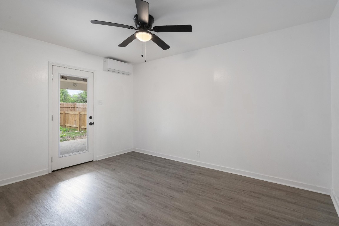 10205 Old Manchaca Road, Unit B Austin, TX 78748 - Photo 5 of 24 an empty room with wooden floor and windows