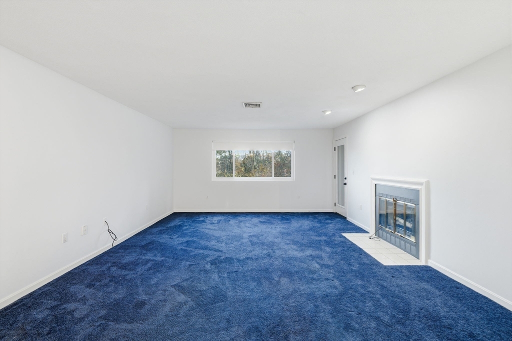 9 Thomas Street, Unit C11 Saugus, MA 01906 - Photo 12 of 42 an empty room with a fireplace and window