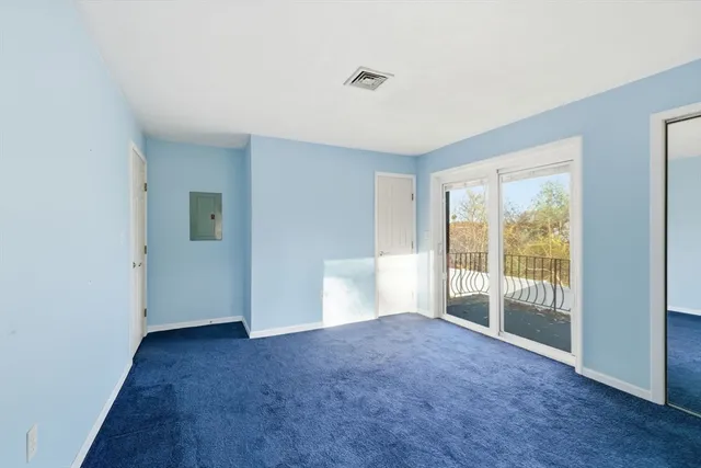 a view of an empty room with glass door