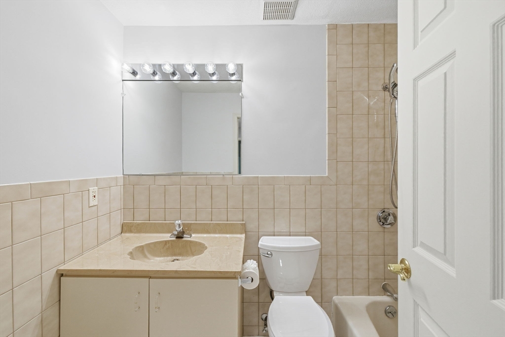 9 Thomas Street, Unit C11 Saugus, MA 01906 - Photo 26 of 42 a bathroom with a toilet sink and mirror