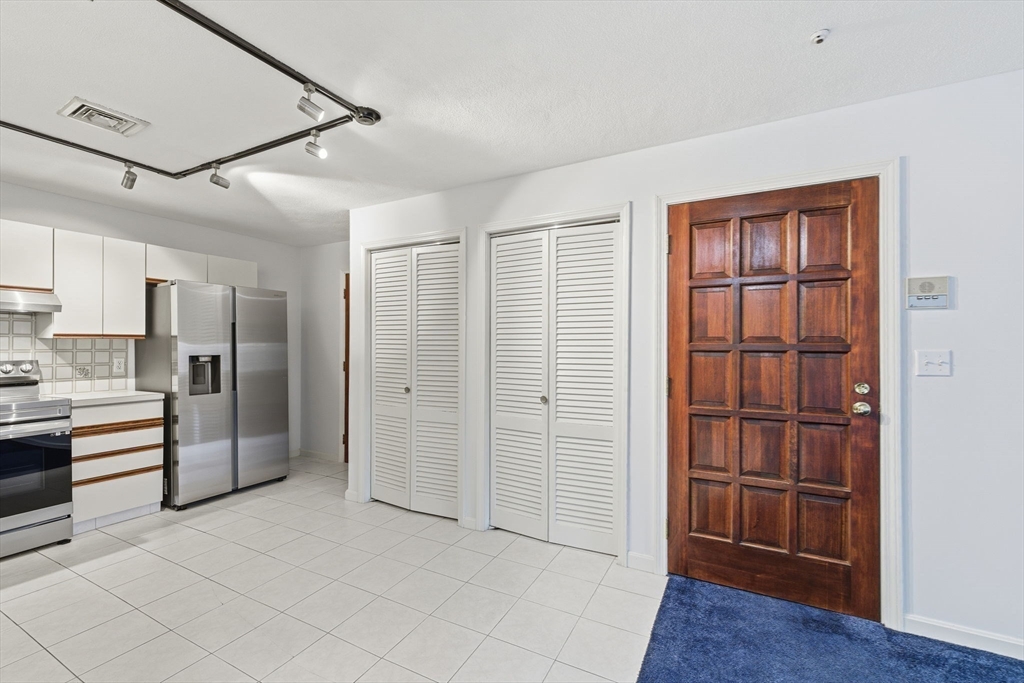 9 Thomas Street, Unit C11 Saugus, MA 01906 - Photo 6 of 42 a view of a kitchen with refrigerator and wooden floor