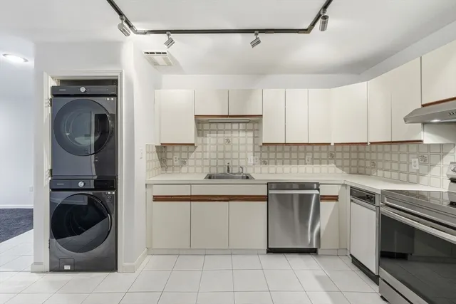 a kitchen with a stove top oven and cabinets