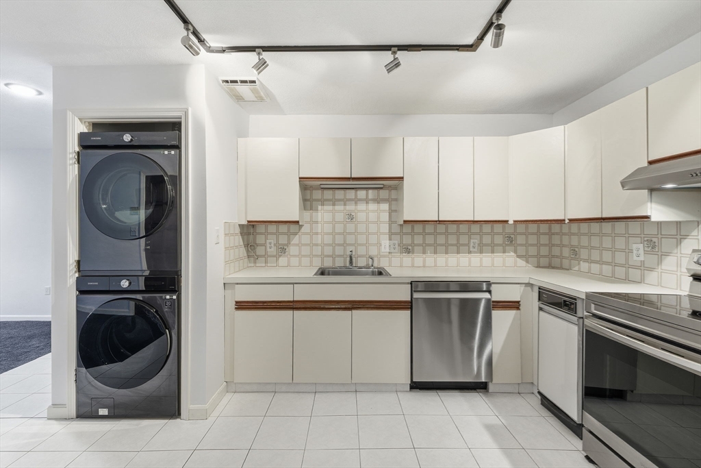 9 Thomas Street, Unit C11 Saugus, MA 01906 - Photo 8 of 42 a kitchen with a stove top oven and cabinets