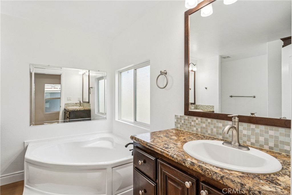10550 Dunlap Crossing Road, Unit 141 Whittier, CA 90606 - Photo 21 of 38 a bathroom with a granite countertop sink and a mirror