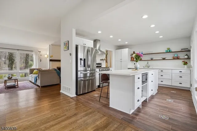 a kitchen with white cabinets and stainless steel appliances