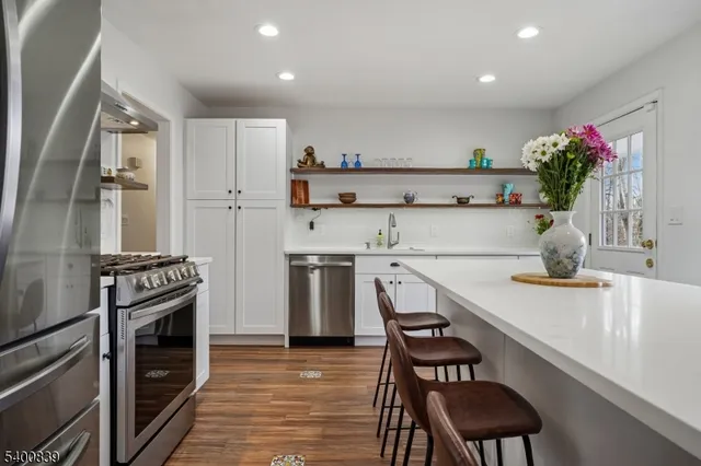 a kitchen with a sink stove and refrigerator