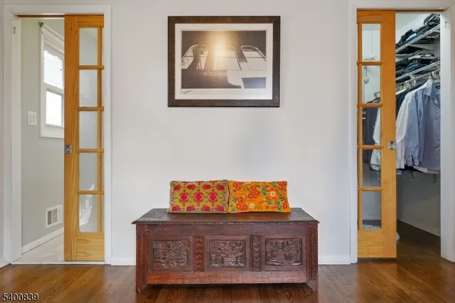 a view of a bedroom with furniture and wooden floor
