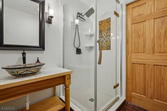 a bathroom with a sink a mirror and shower