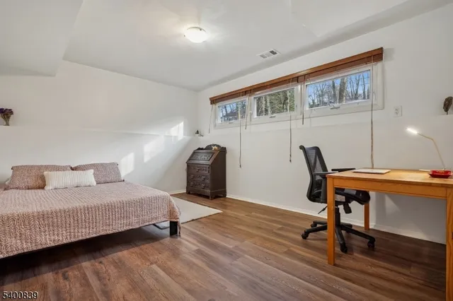 a bedroom with furniture and a window