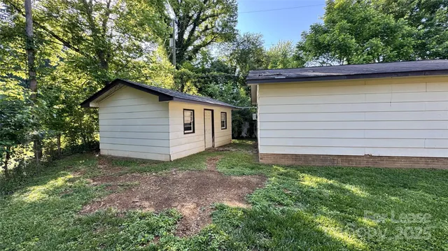 a view of a backyard with large trees