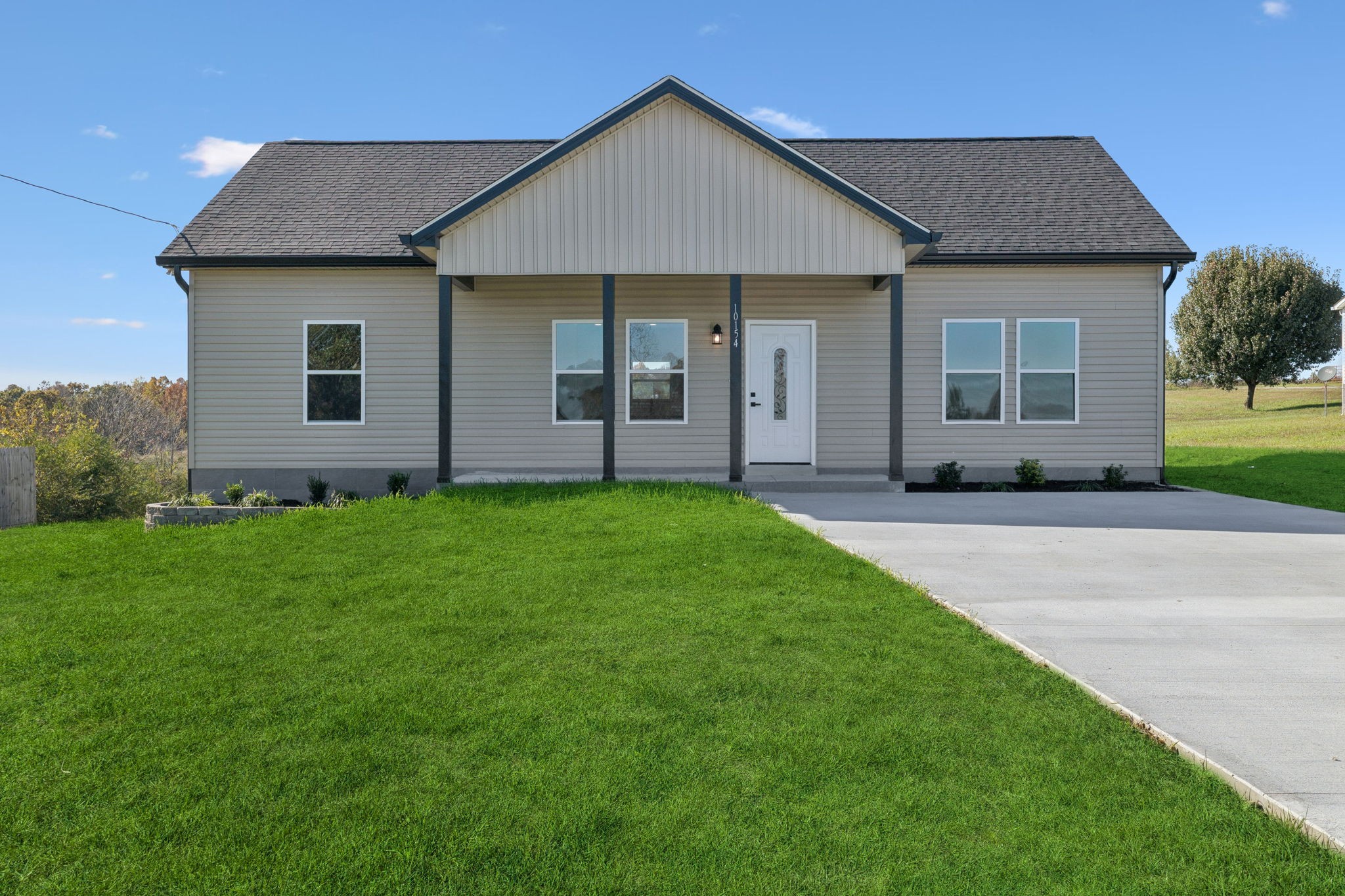 10154 Rocky Point Road Bon Aqua, TN 37025 - Photo 1 of 26 a front view of a house with garden
