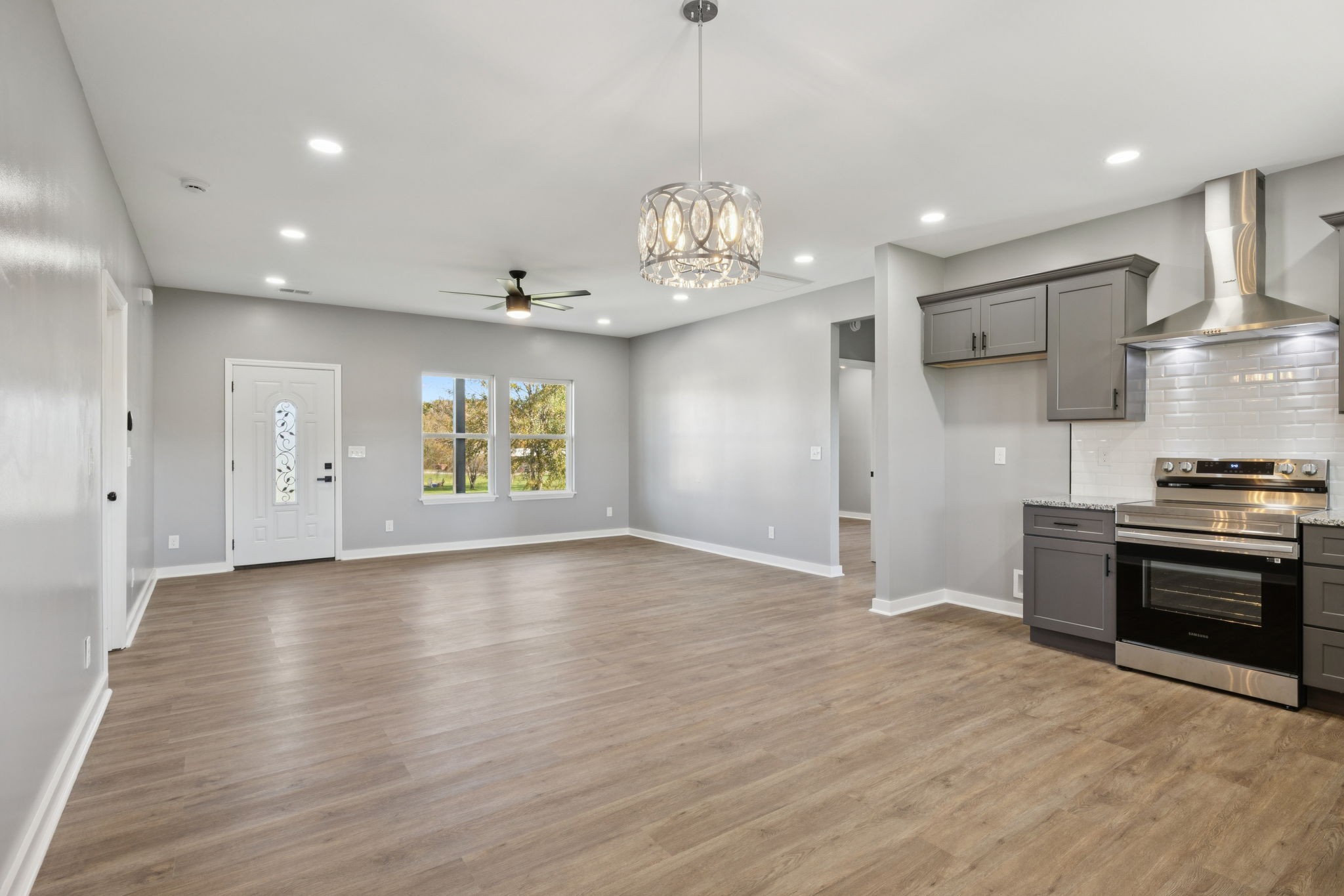 10154 Rocky Point Road Bon Aqua, TN 37025 - Photo 11 of 26 a view of an empty room with kitchen stove and wooden floor