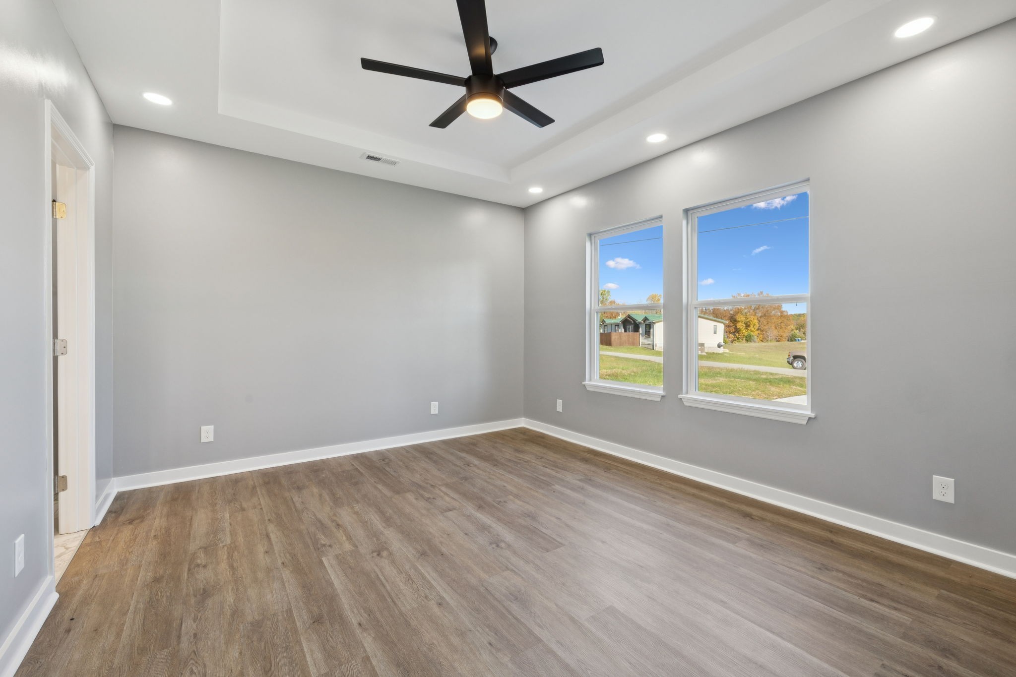 10154 Rocky Point Road Bon Aqua, TN 37025 - Photo 12 of 26 wooden floor in an empty room with a window