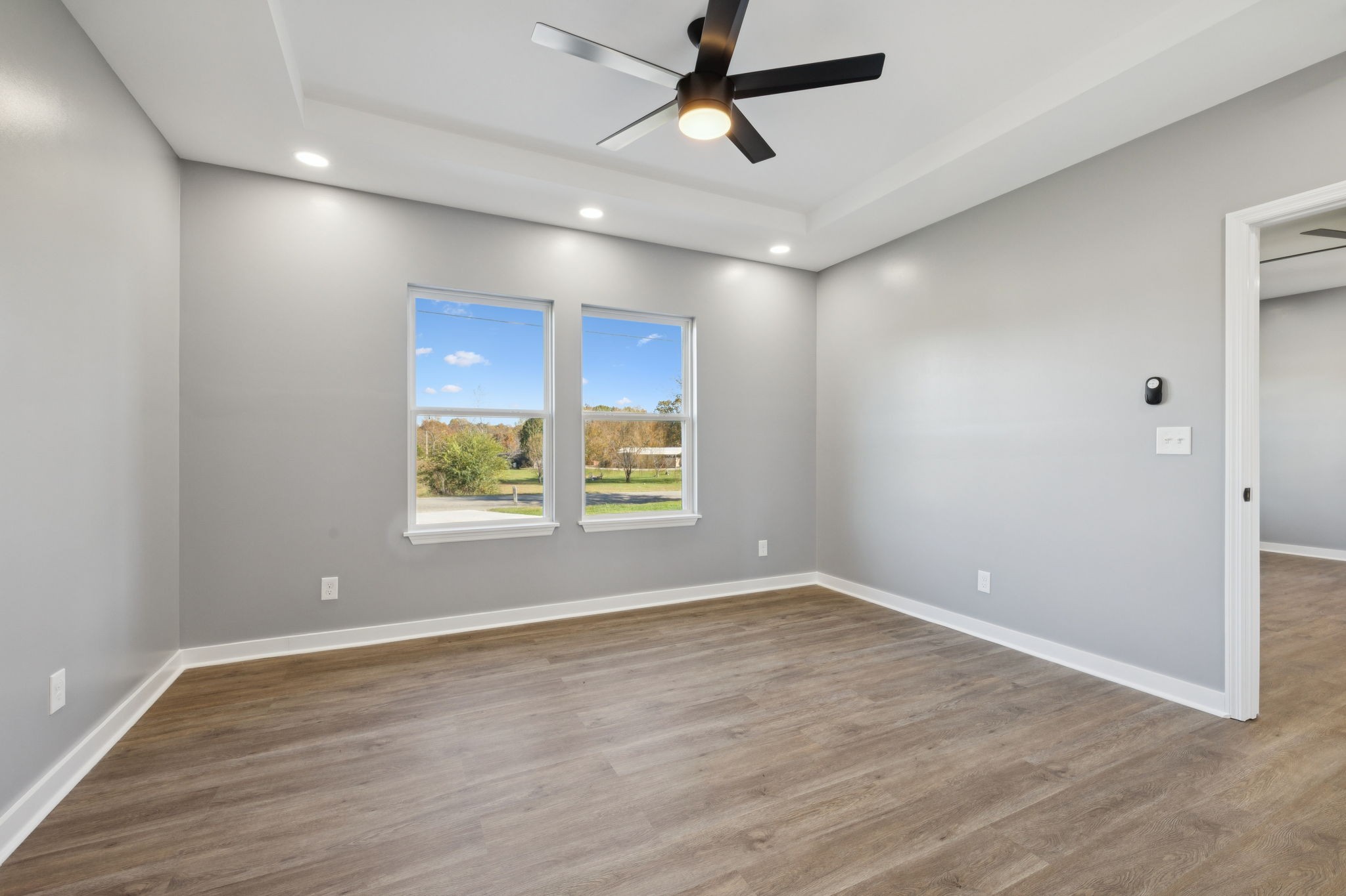 10154 Rocky Point Road Bon Aqua, TN 37025 - Photo 13 of 26 an empty room with wooden floor and windows