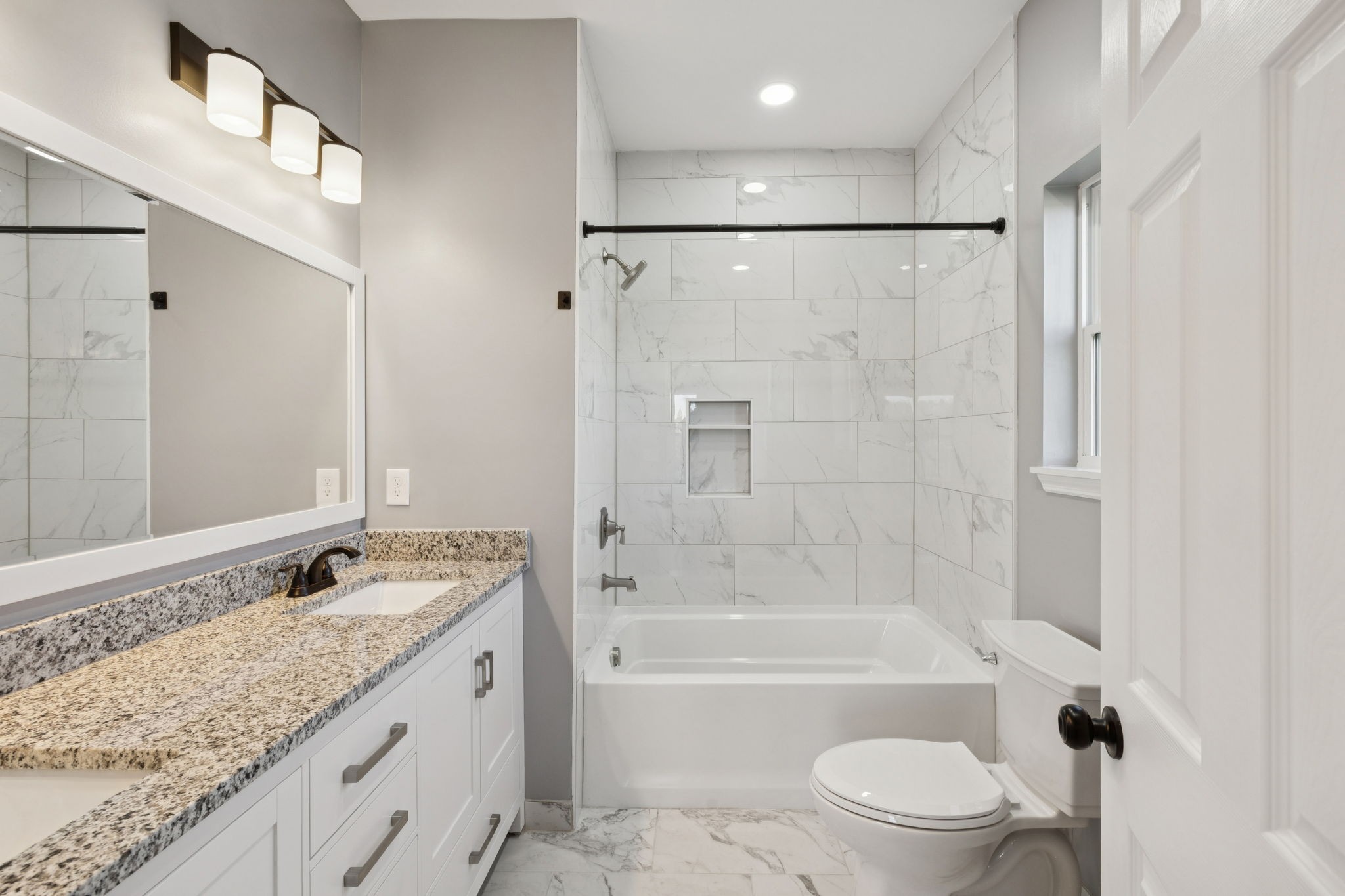 10154 Rocky Point Road Bon Aqua, TN 37025 - Photo 14 of 26 a bathroom with a granite countertop sink a toilet and shower