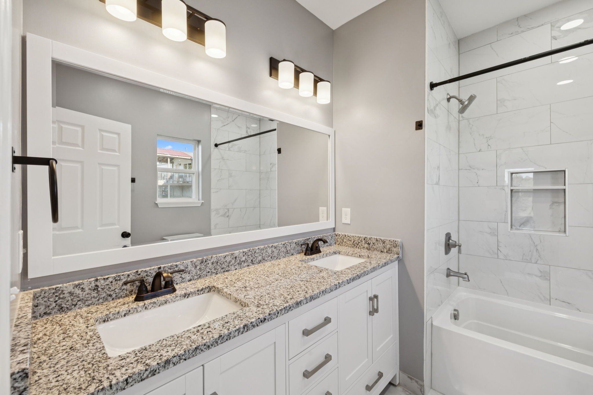 10154 Rocky Point Road Bon Aqua, TN 37025 - Photo 15 of 26 a bathroom with a granite countertop double vanity sink and mirror with bathtub