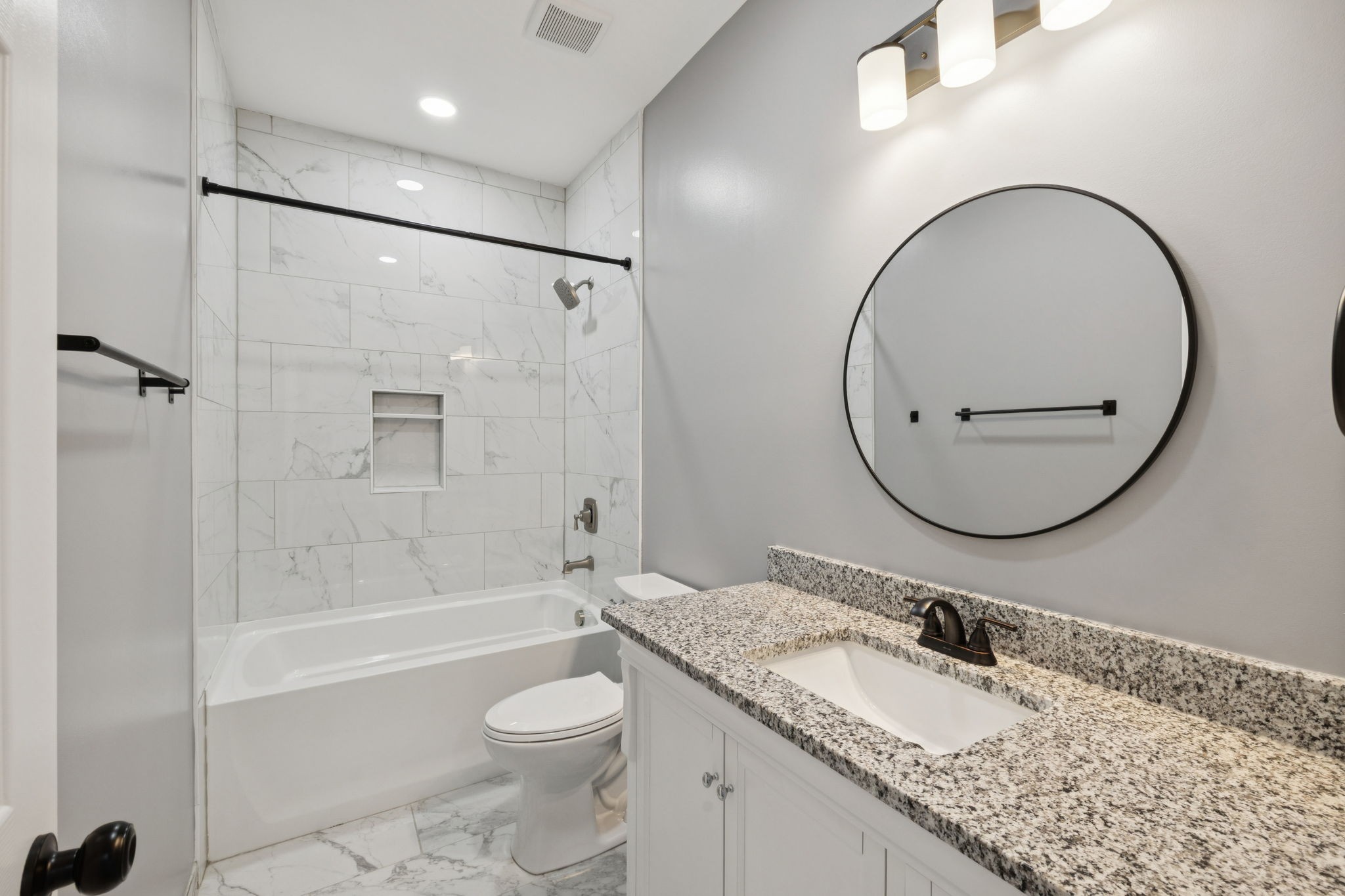 10154 Rocky Point Road Bon Aqua, TN 37025 - Photo 18 of 26 a bathroom with a granite countertop sink toilet mirror and shower