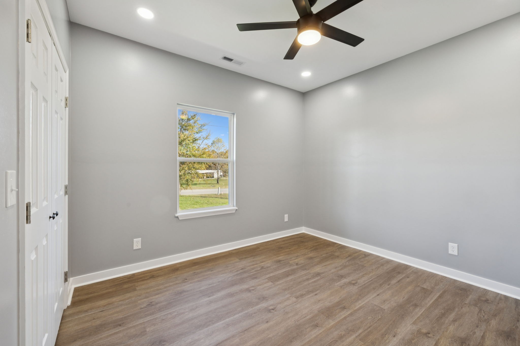10154 Rocky Point Road Bon Aqua, TN 37025 - Photo 19 of 26 wooden floor in an empty room with a window