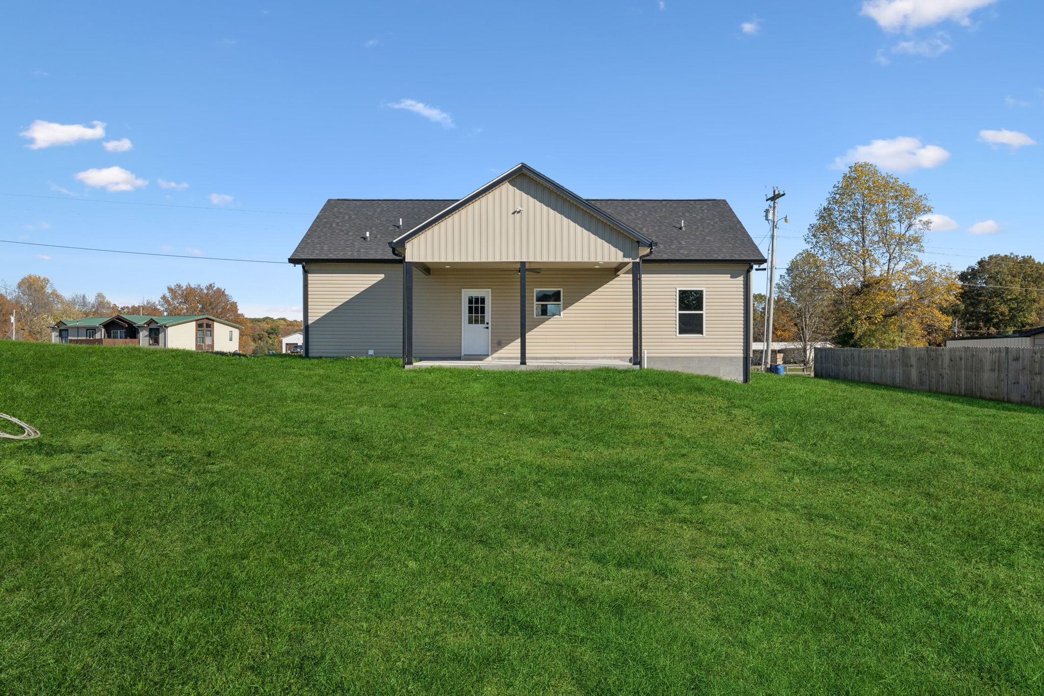 10154 Rocky Point Road Bon Aqua, TN 37025 - Photo 23 of 26 a view of a house with a yard and garage