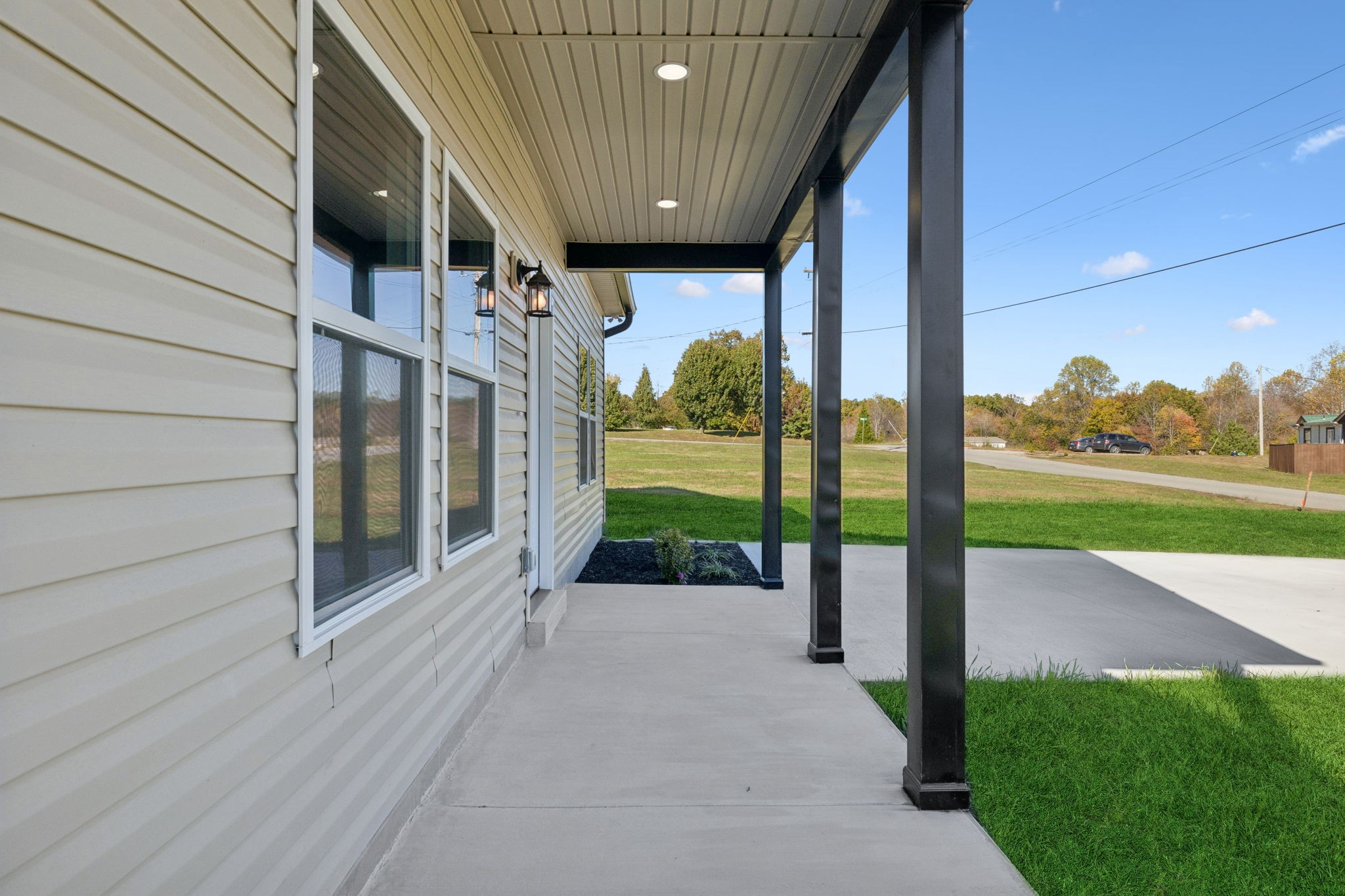 10154 Rocky Point Road Bon Aqua, TN 37025 - Photo 4 of 26 a view of a porch with a garden