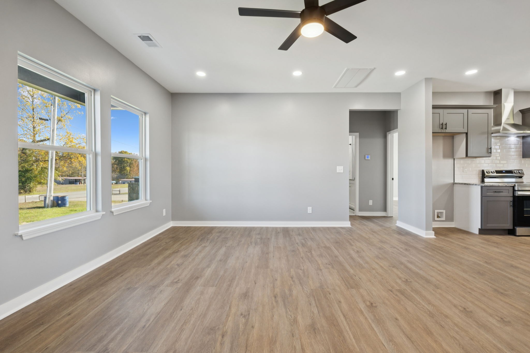 10154 Rocky Point Road Bon Aqua, TN 37025 - Photo 6 of 26 a view of an empty room with a window and wooden floor
