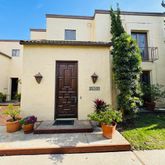a view of a house with potted plants