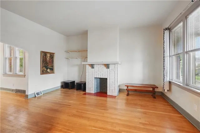 a view of a livingroom with wooden floor and a ceiling fan
