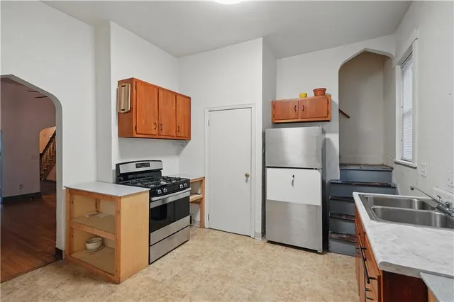a kitchen with stainless steel appliances a stove and a refrigerator