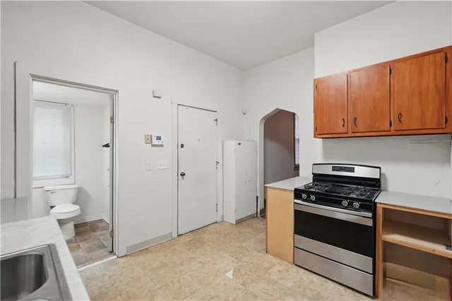 a spacious bathroom with a double vanity sink a mirror and a shower