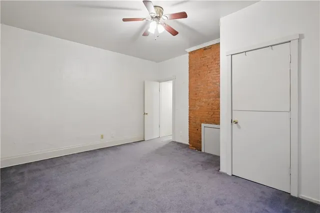 a view of a livingroom with a chandelier fan