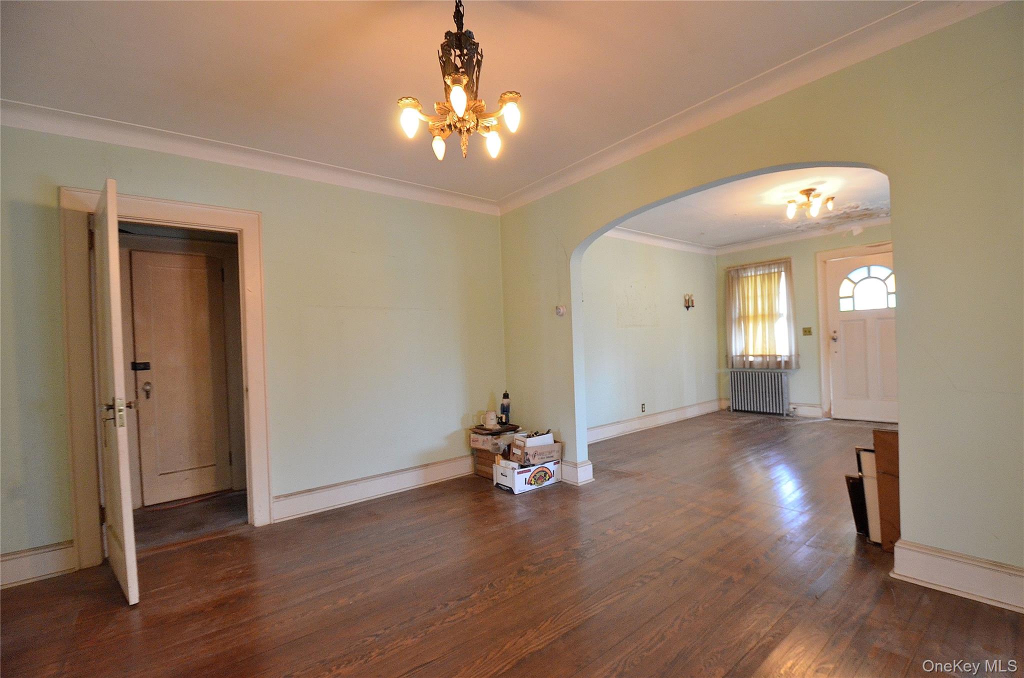 2586 Riverside Drive Wantagh, NY 11793 - Photo 9 of 28 Dining Room featuring a solid wood door, hardwood flooring, and crown molding