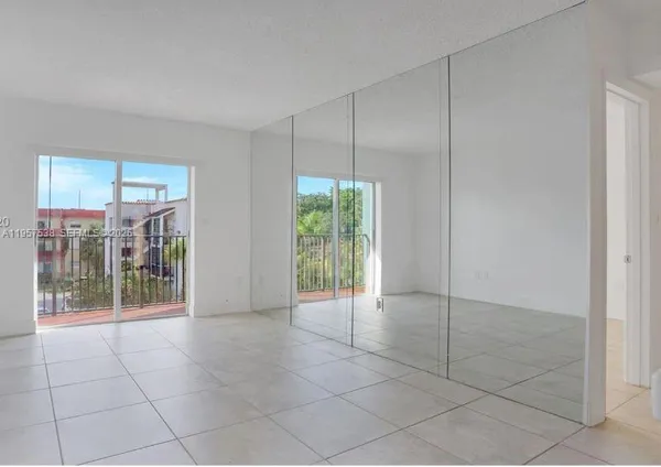a view of an empty room with glass door