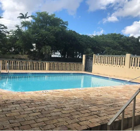 a view of swimming pool with deck and lake view