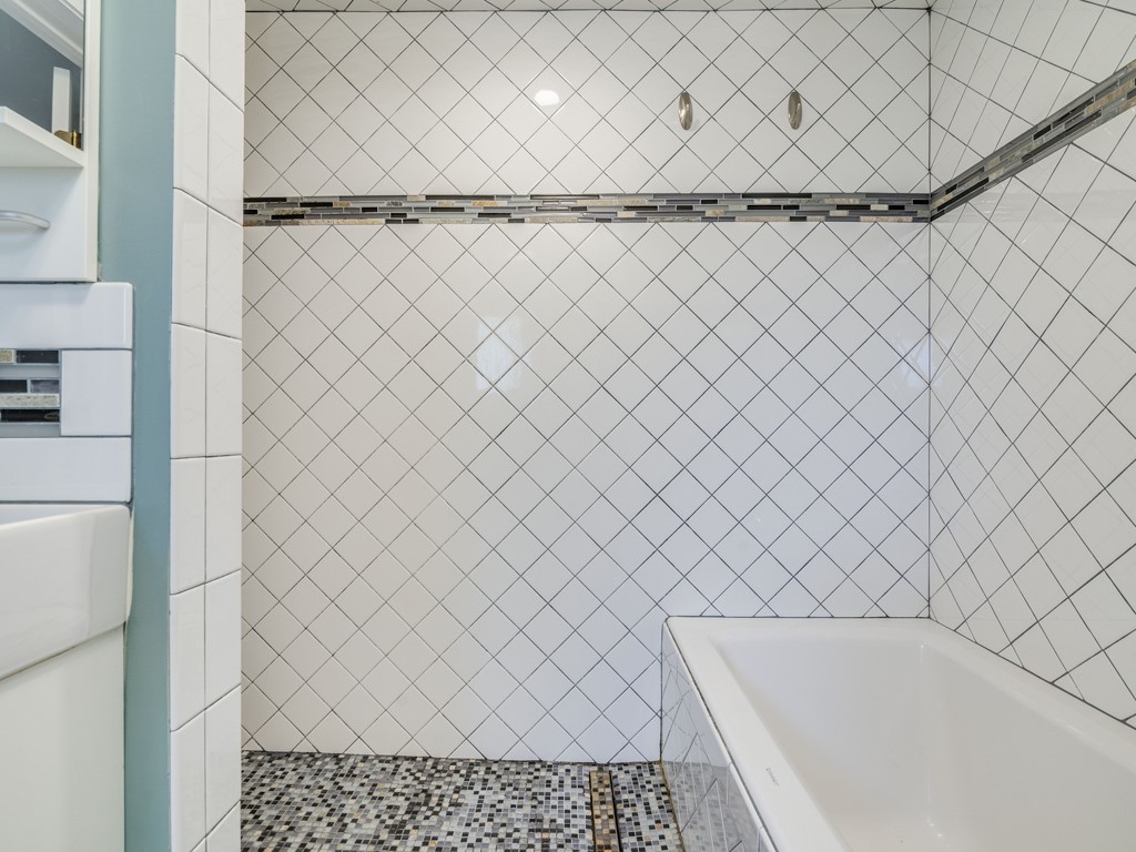 2314 Santa Rosa Street Austin, TX 78702 - Photo 12 of 27 Full bathroom with a garden tub and a tile shower