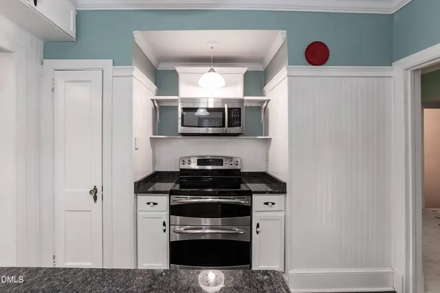 a kitchen with stainless steel appliances a sink stove and cabinets