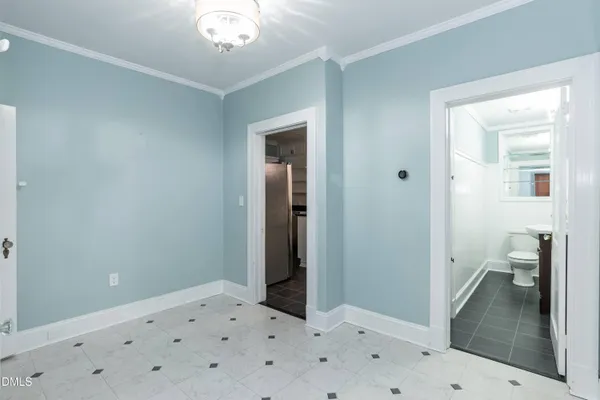 a view of a hallway with wooden floor and closet