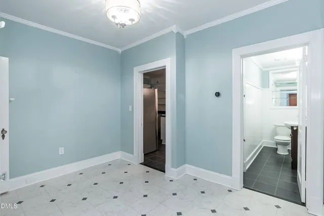 a view of a hallway with wooden floor and closet