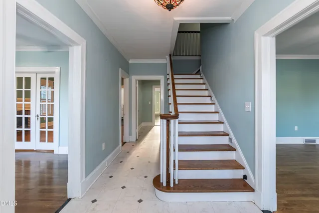 a view of a hallway with wooden floor and entryway