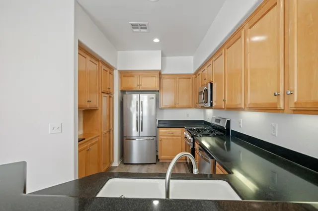 a kitchen with a refrigerator a sink and a cabinets
