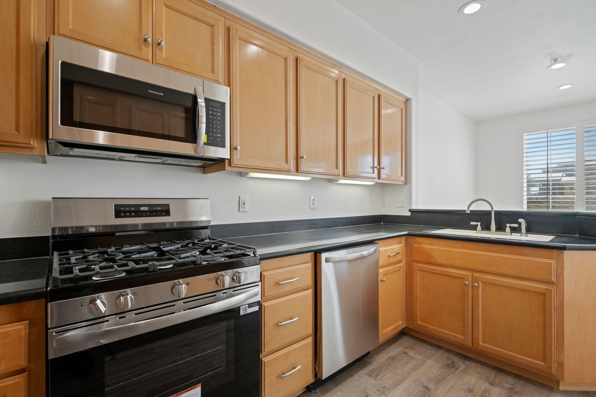 541 Sweet Rain Place Goleta, CA 93117 - Photo 13 of 40 a kitchen with stainless steel appliances granite countertop grey cabinets a stove a sink and dishwasher