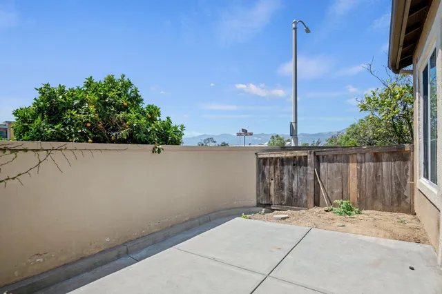 a view of a terrace with a wooden fence