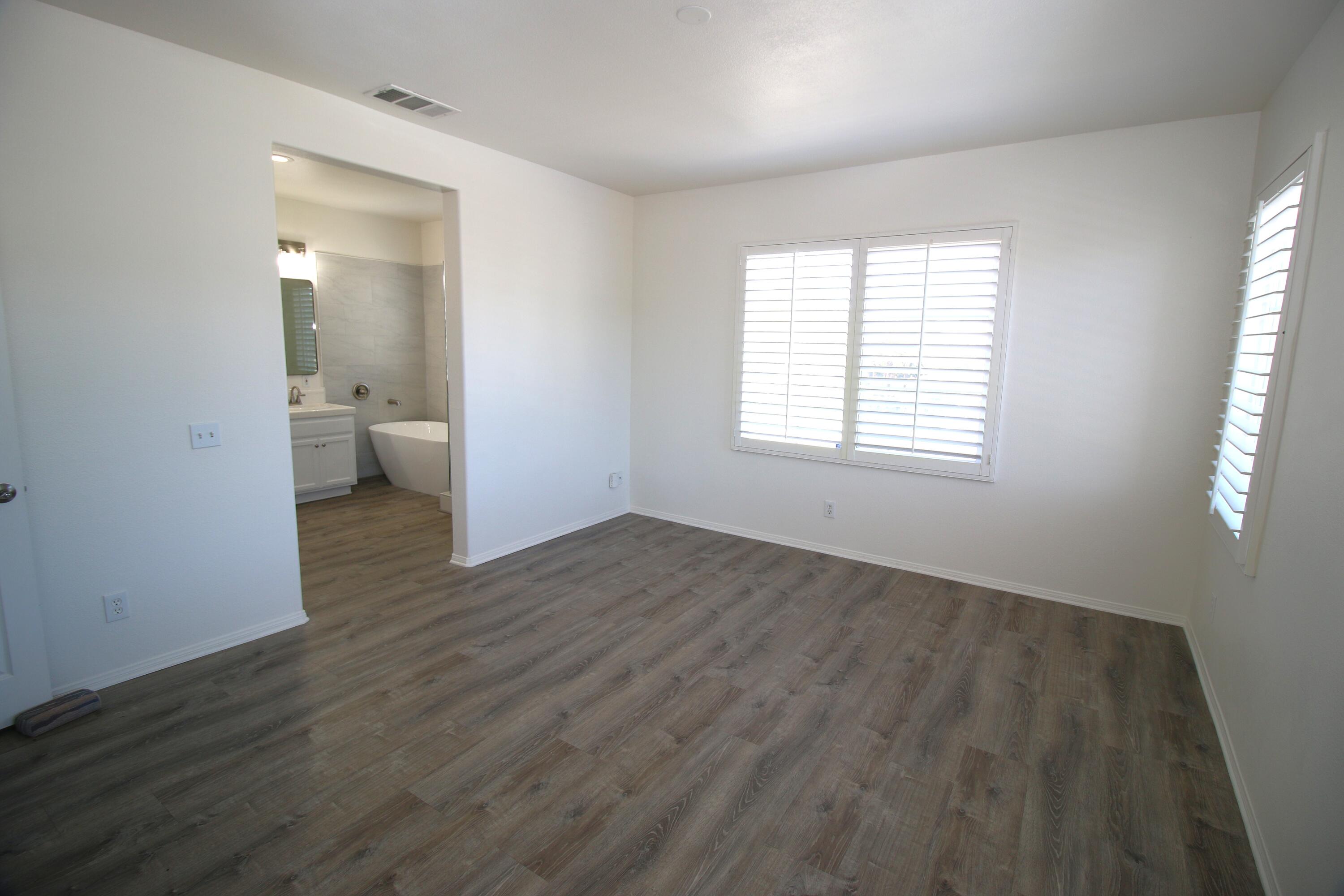 541 Sweet Rain Place Goleta, CA 93117 - Photo 16 of 40 an empty room with wooden floor and windows