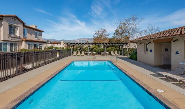 a view of swimming pool with a lounge chairs