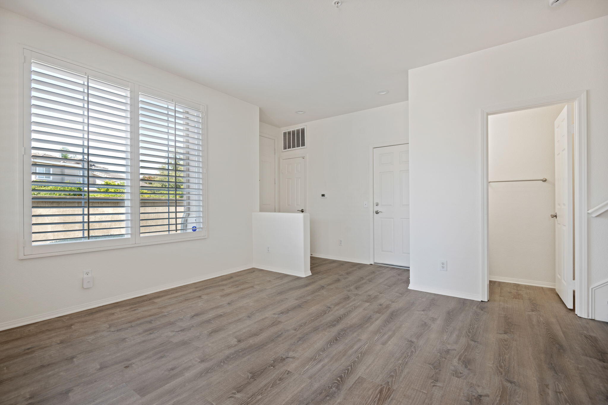 541 Sweet Rain Place Goleta, CA 93117 - Photo 3 of 40 an empty room with wooden floor and windows