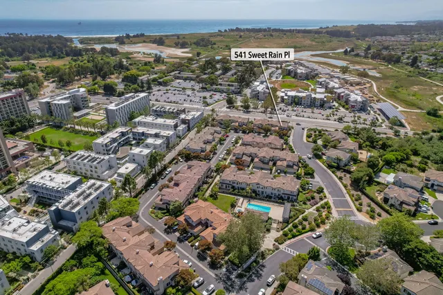 an aerial view of residential building and lake