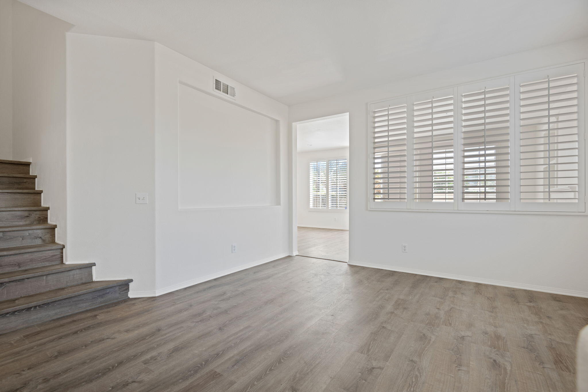 541 Sweet Rain Place Goleta, CA 93117 - Photo 4 of 40 a view of an empty room with wooden floor and a window