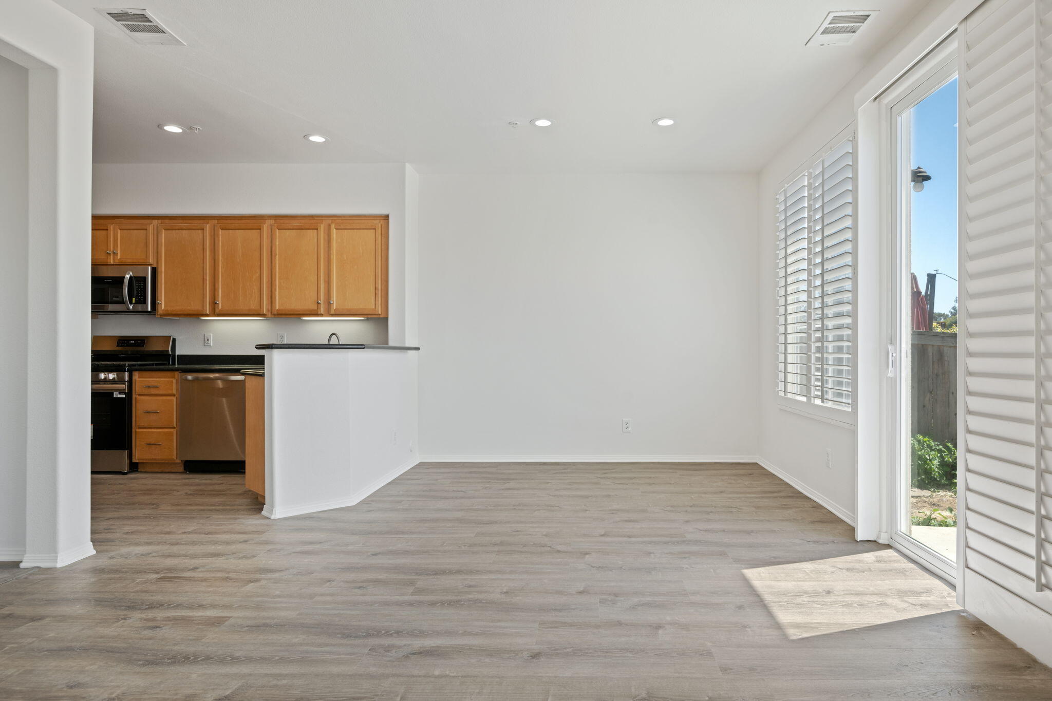541 Sweet Rain Place Goleta, CA 93117 - Photo 10 of 40 wooden floor in an empty room with kitchen view