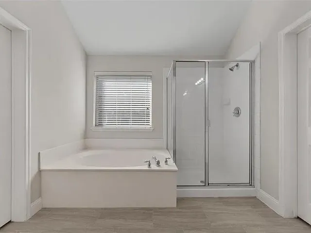 a bathroom with a bathtub and a shower