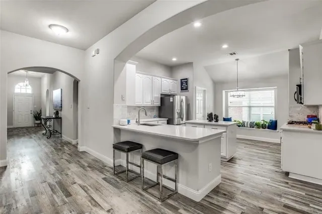 a kitchen with counter top space a sink cabinets and appliances