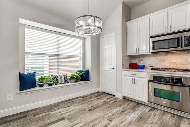 a kitchen with stainless steel appliances a stove and cabinets